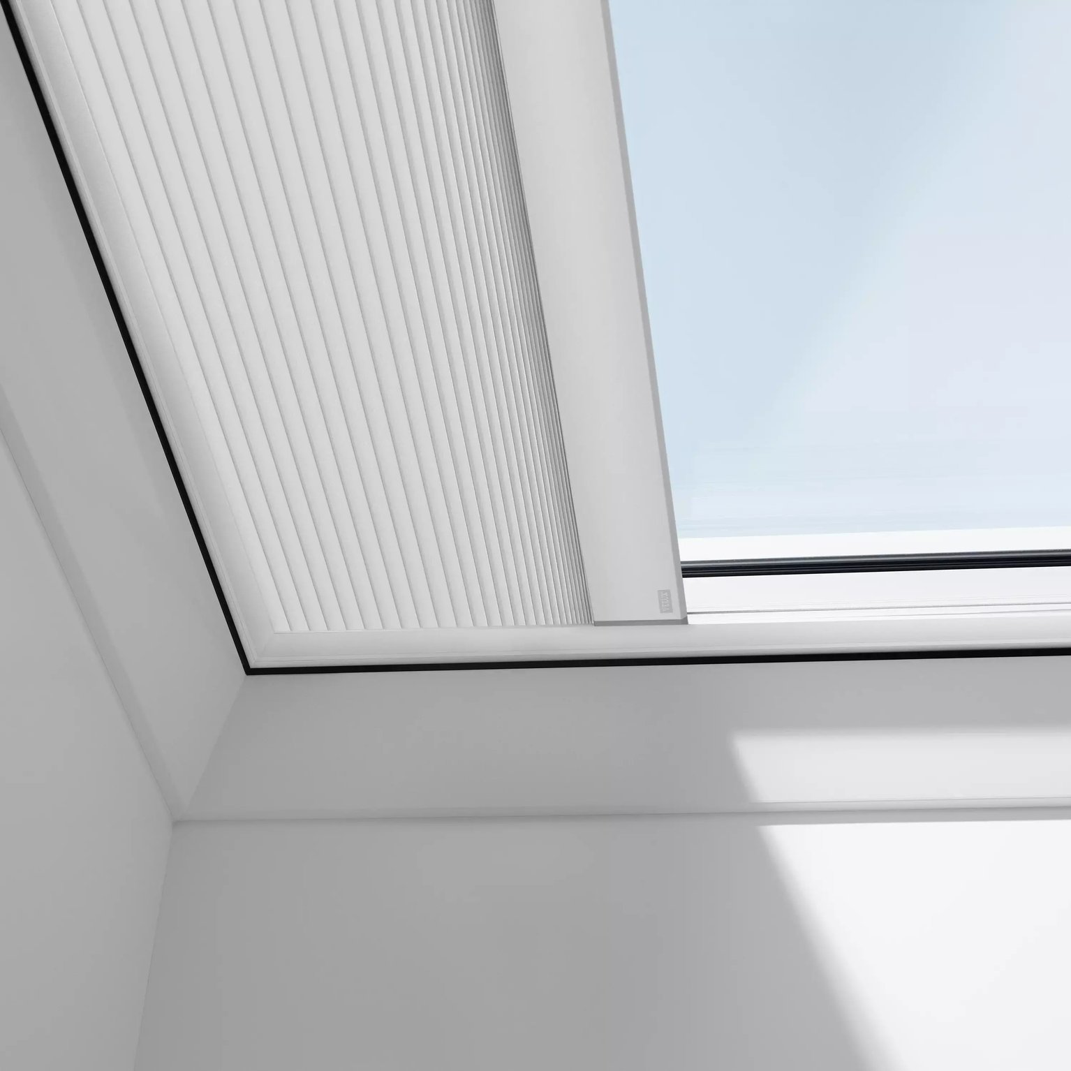 VELUX roof window with integrated blinds on a sloped ceiling.