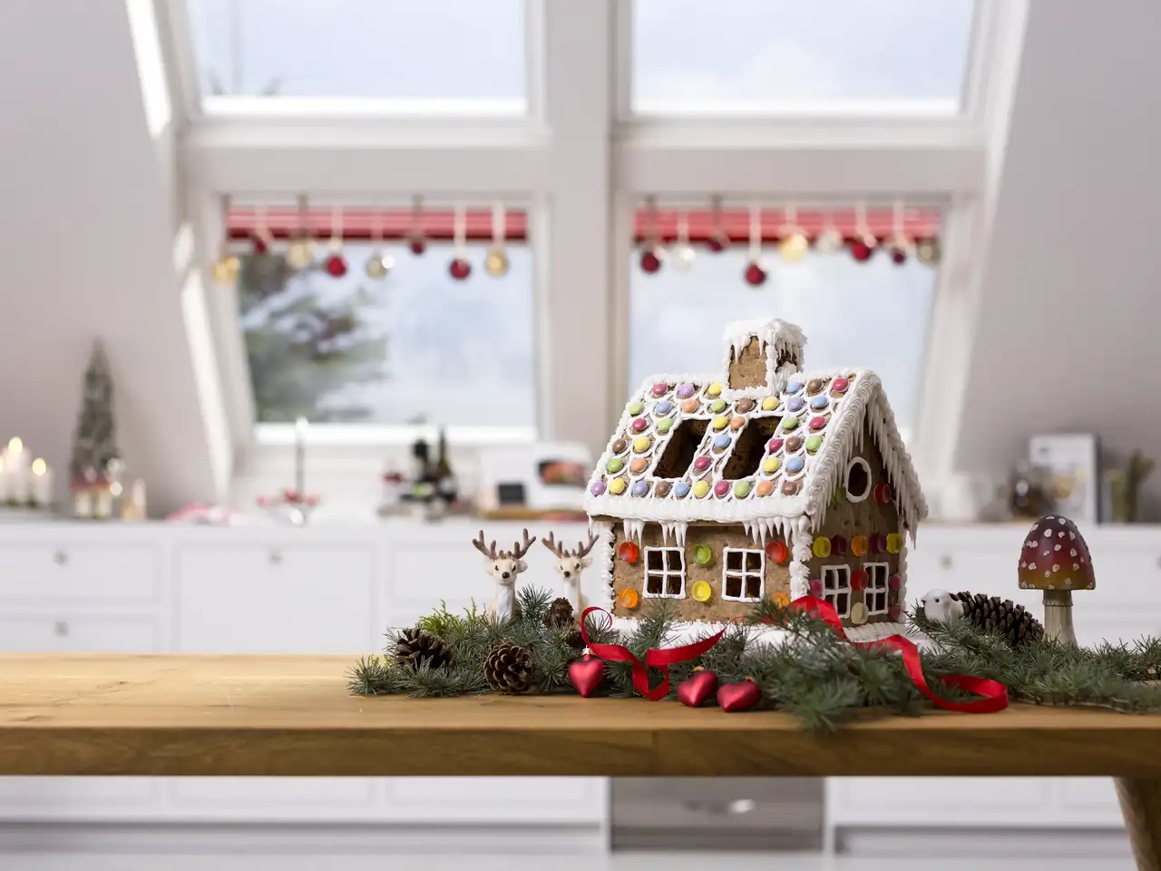 Attic room with gingerbread house and festive decorations, large roof windows