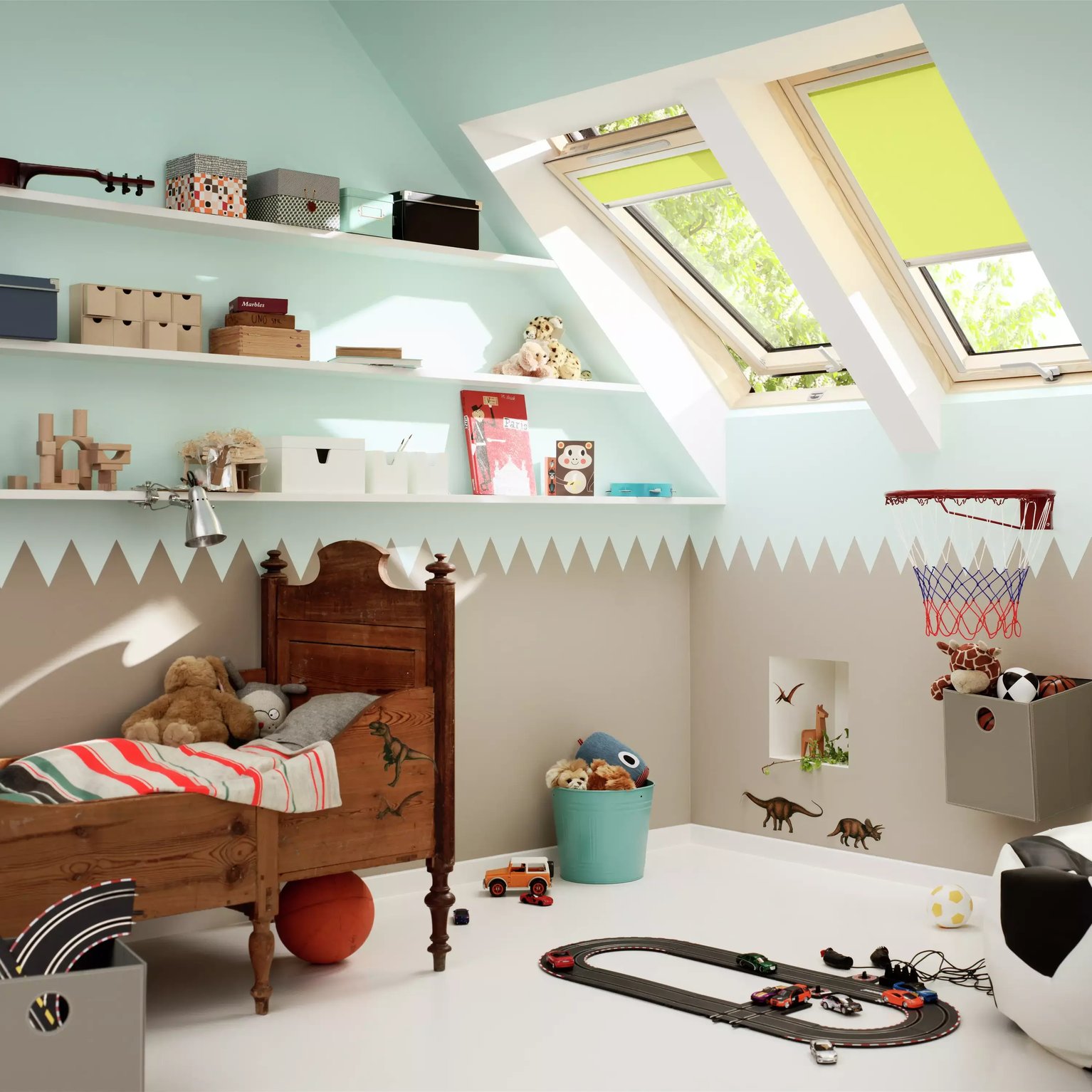 Kids room with sloped ceiling and VELUX roof windows, toys and books.