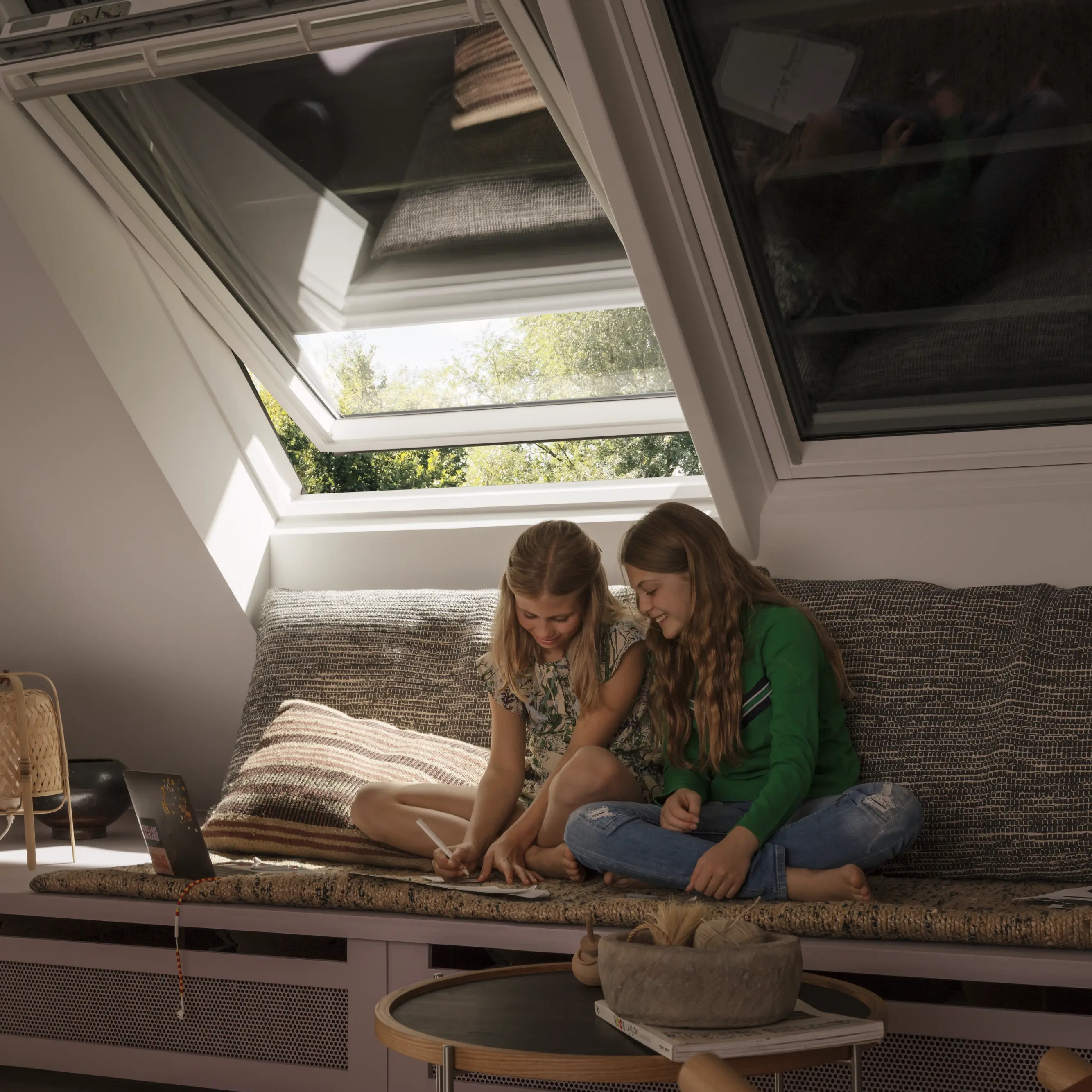 Attic room with VELUX roof windows, cozy seating area, natural light.