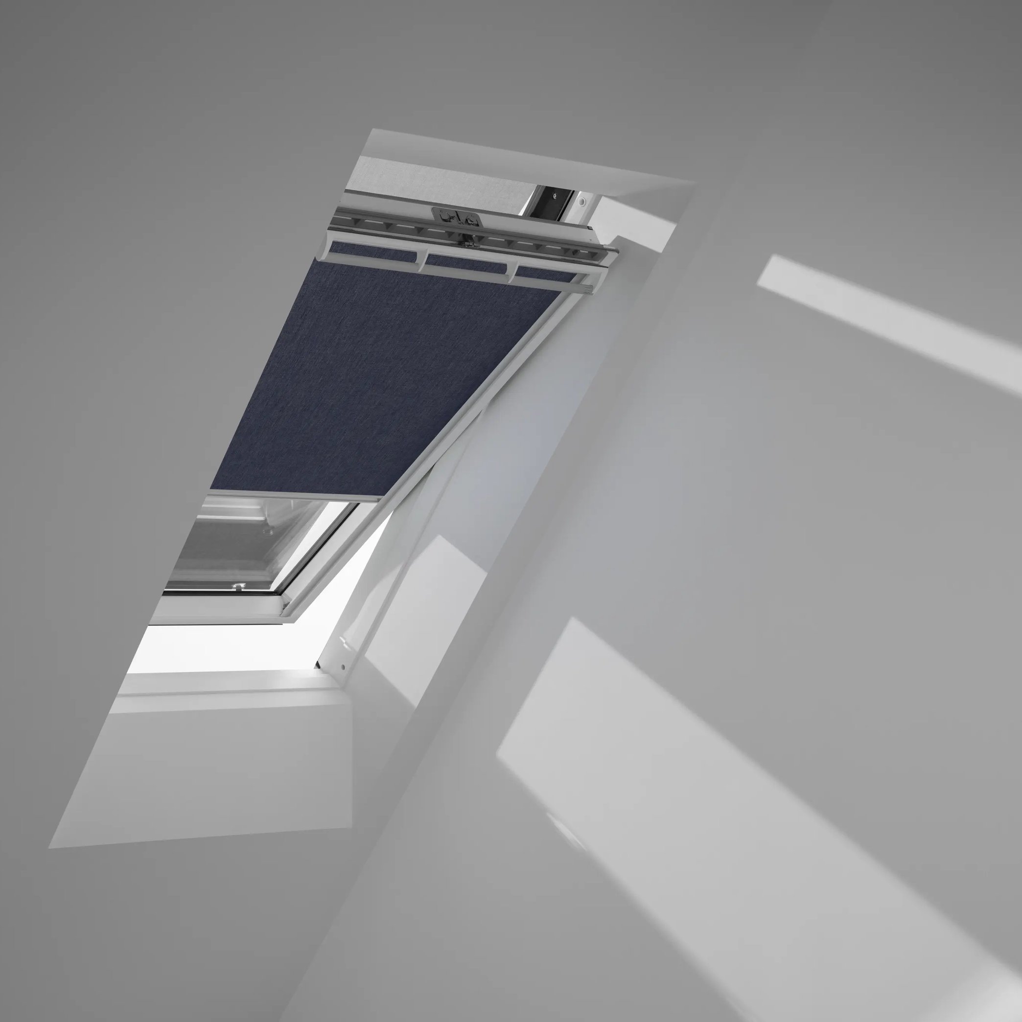 Attic with sloped ceiling and partially open VELUX roof window.