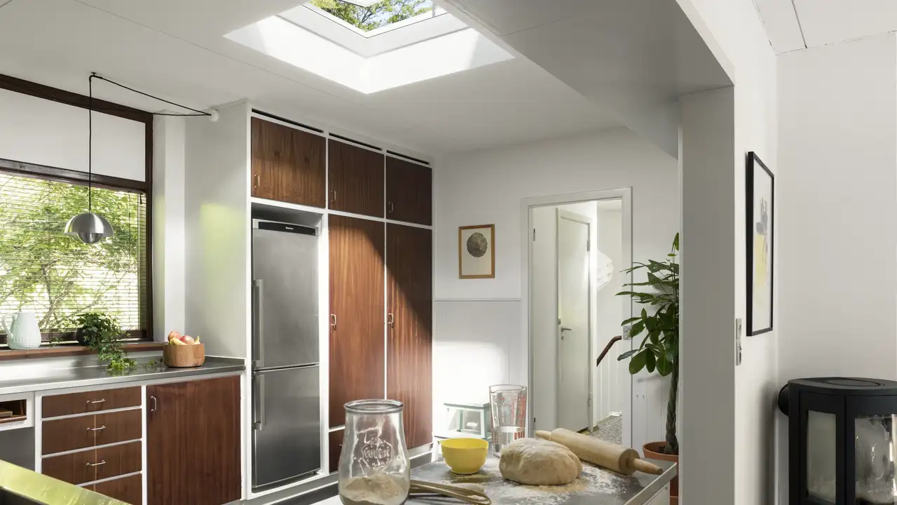 VELUX Standard glass rooflight above modern kitchen extension with wood cabinets - mid-range flat rooflight for renovations. 