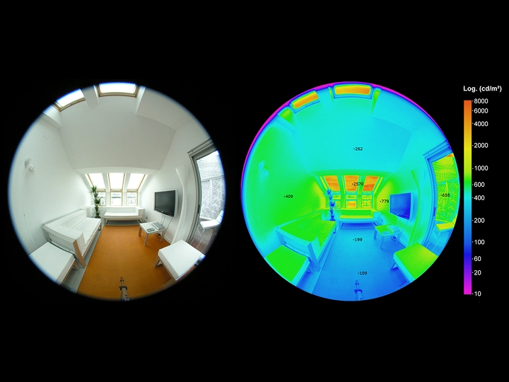 Attic living room with sloped ceiling and VELUX roof windows, bright and airy.