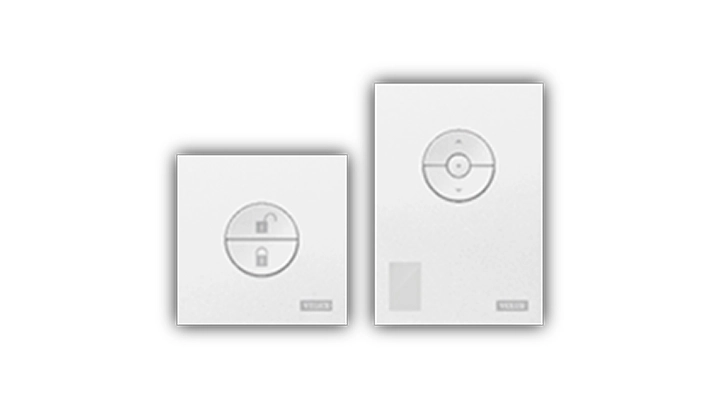 Two VELUX remote controls for roof windows and blinds.