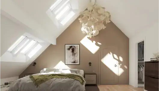 des fenêtres de toit VELUX éclairent une chambre sous combles mansardés