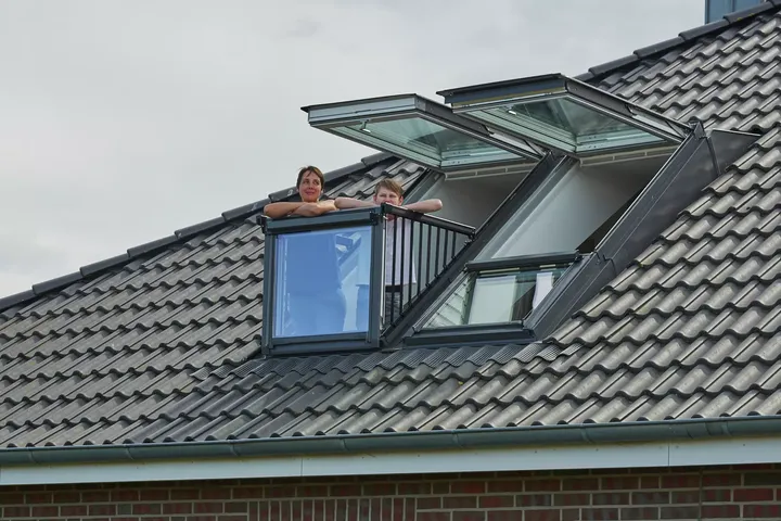 VELUX Dachflächenfenster, das sich auf einem Ziegeldach zu einem Balkon öffnet