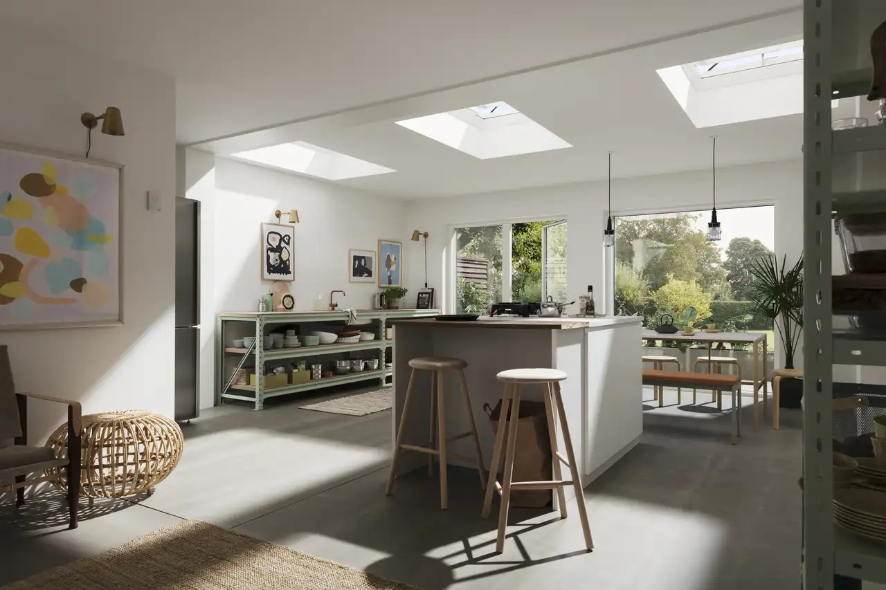 "Spacieuse extension de cuisine au style moderne, avec un îlot central équipé de tabourets, mettant en valeur la lumière naturelle dans la pièce."
