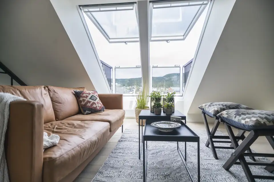 Living room in the loft with two VELUX roof balconies