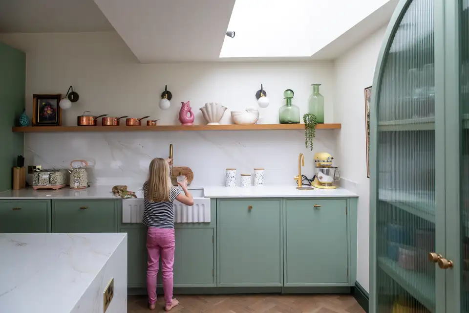 A colourful kitchen, featuring a large skylight that adds natural light and elegance