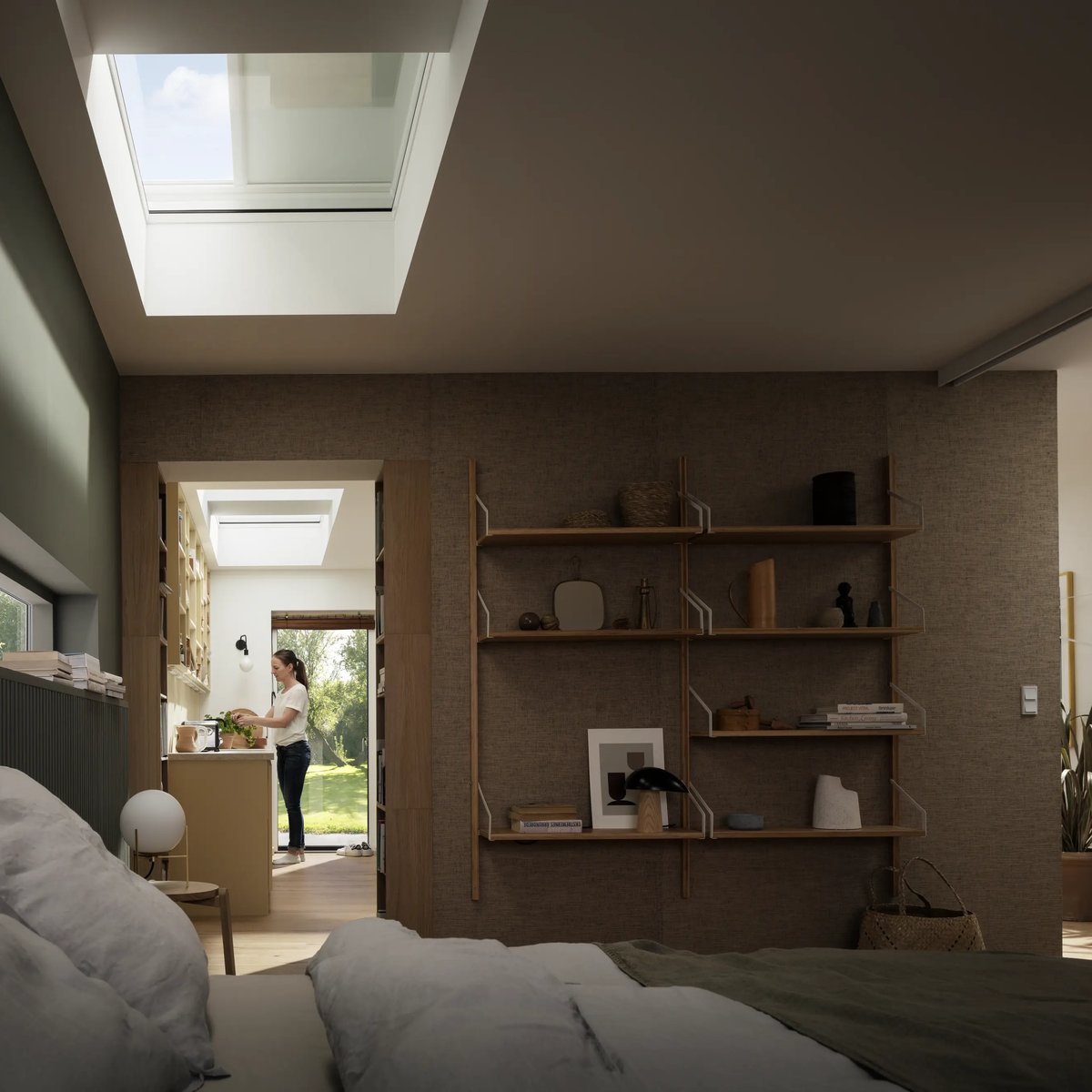 Bedroom with VELUX roof window, natural light, and adjacent kitchen area.