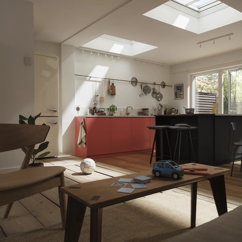 Modern kitchen with red cabinets and VELUX roof window, natural light entering.