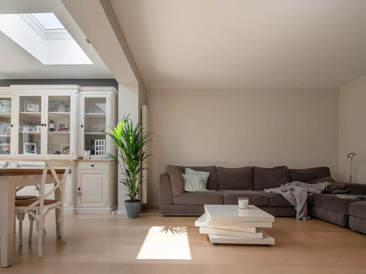 Living room with sofa, coffee table, and VELUX roof window providing natural light.