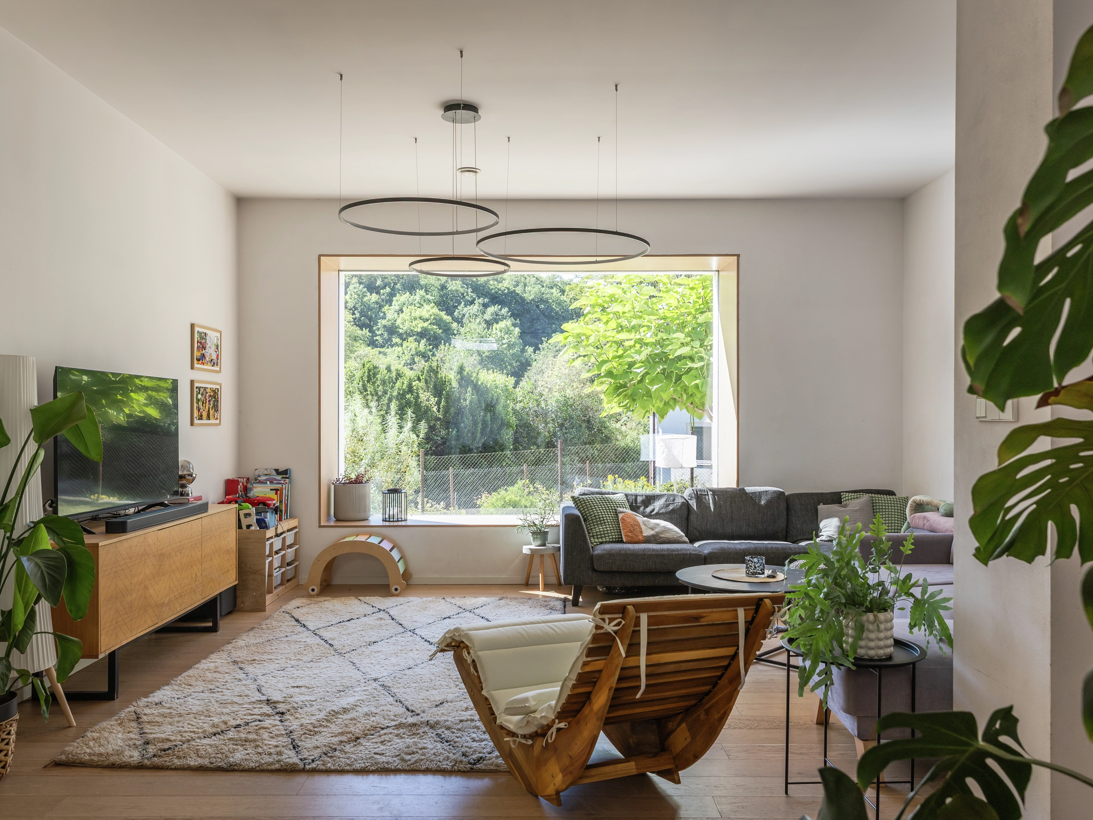 Living room with large window and modern decor.
