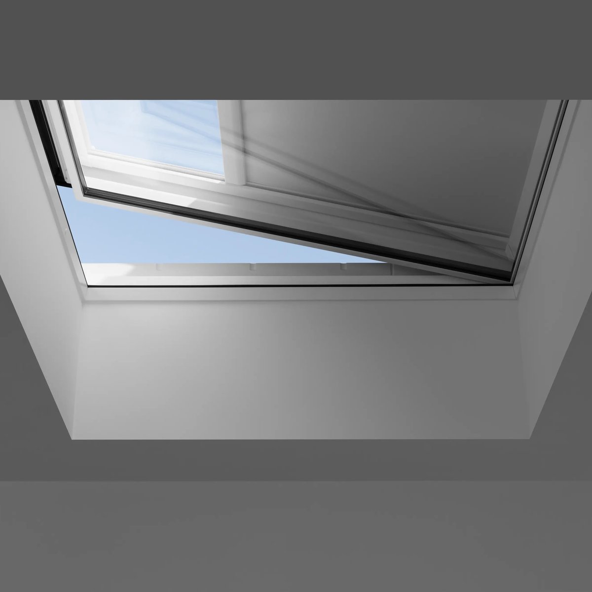 Open VELUX roof window with clear sky view.