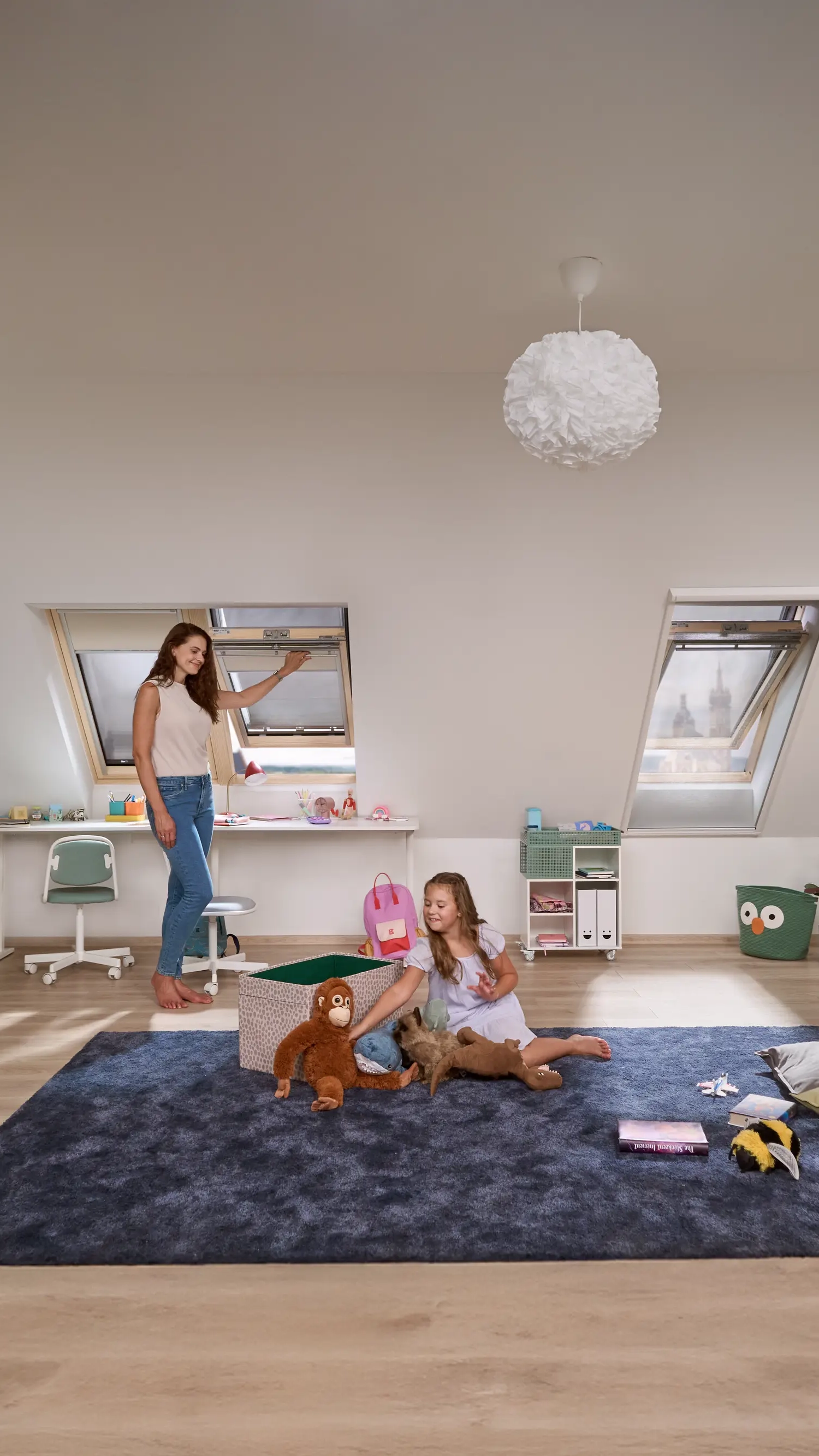 Kids room with bunk beds, play tent, and VELUX roof windows.