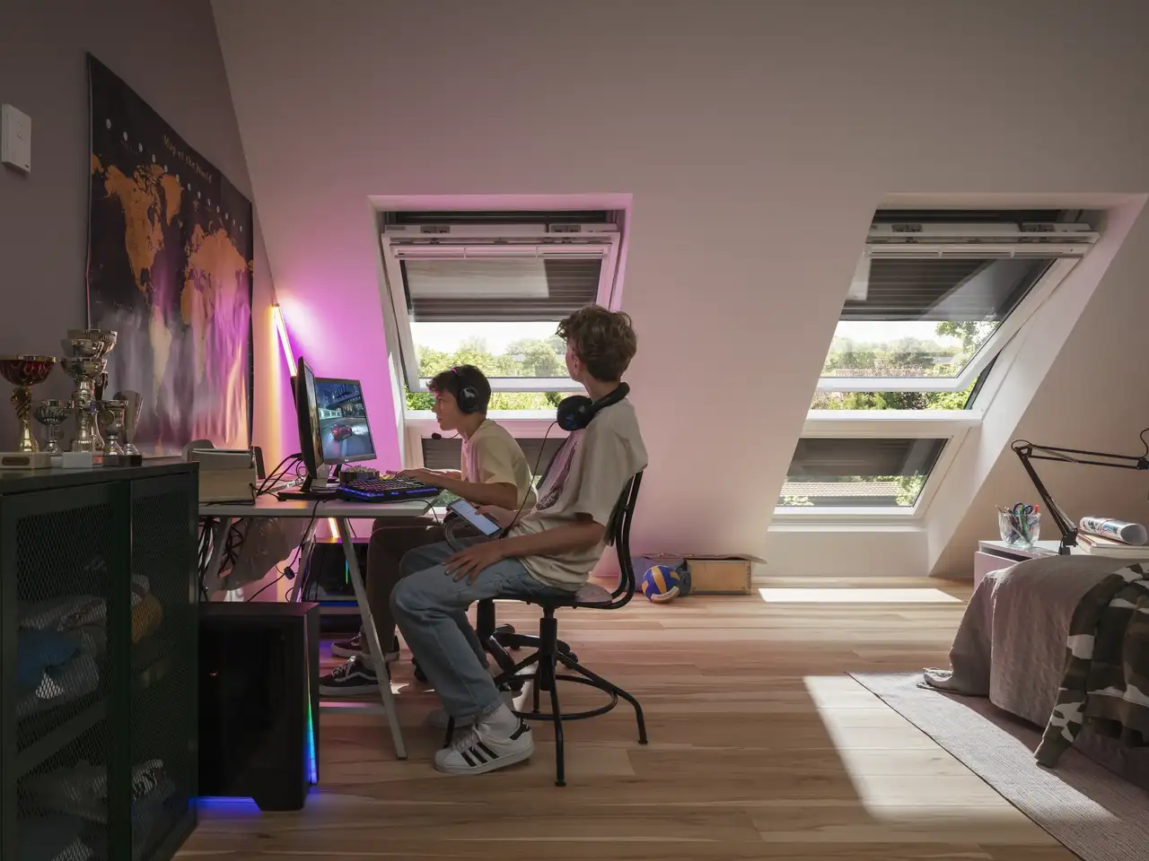 Deux adolescents jouent aux jeux vidéo alors que les fenêtres de toit sont ouvertes | Magazine VELUX