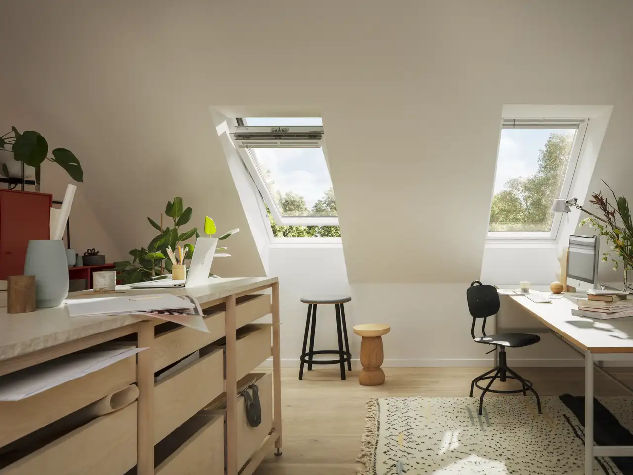 Attic workspace with sloped ceiling and open VELUX roof windows