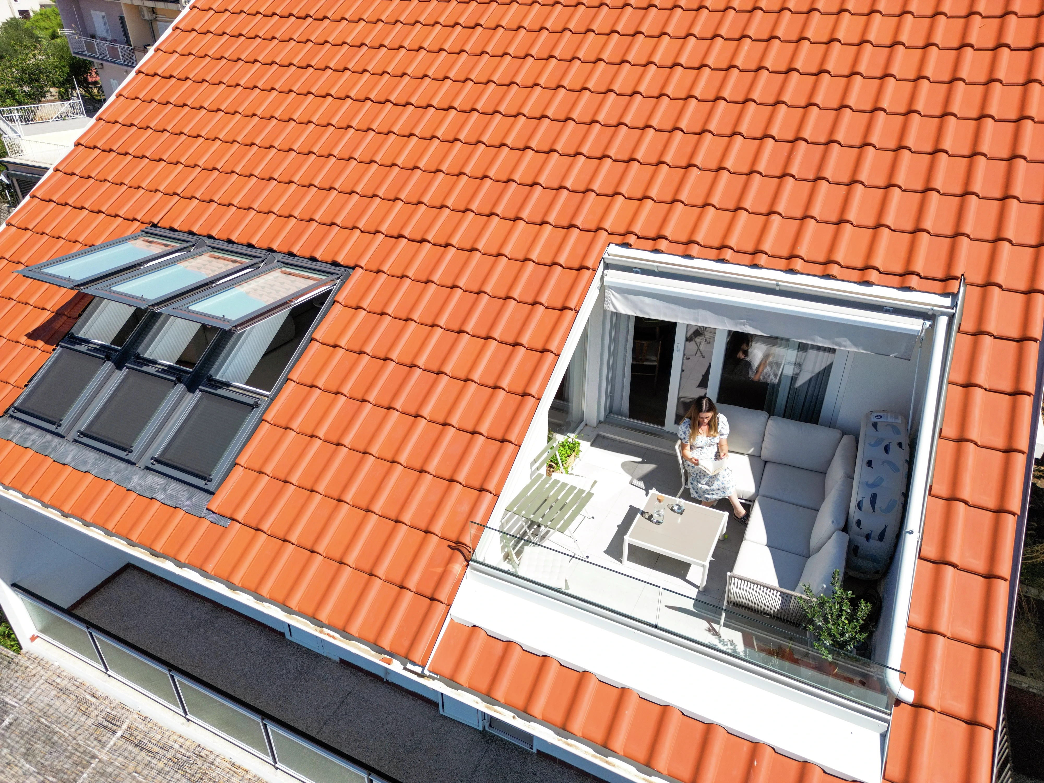 Rooftop terrace with VELUX windows and seating area.
