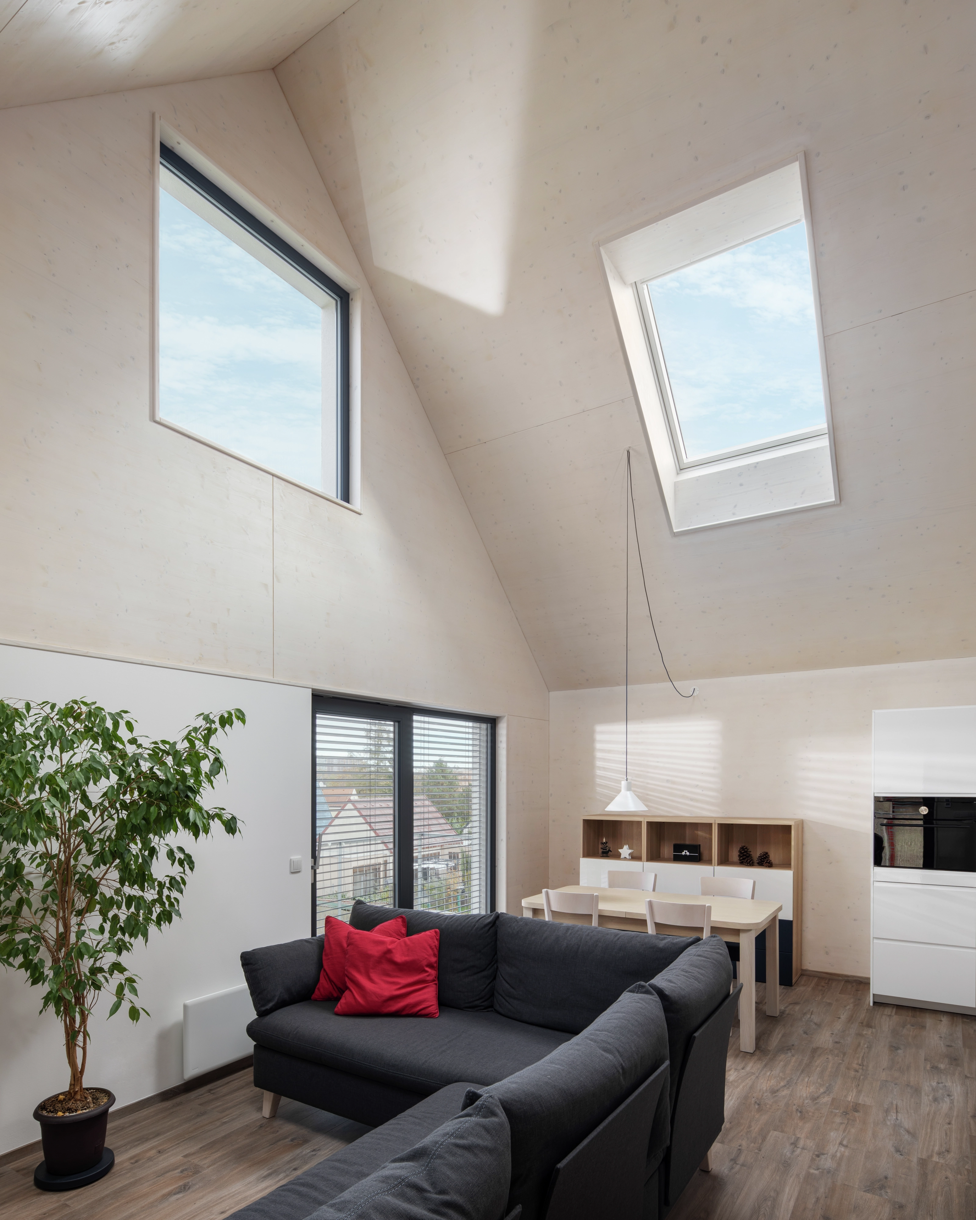 Attic living space with sloped ceiling and VELUX roof window, modern design.