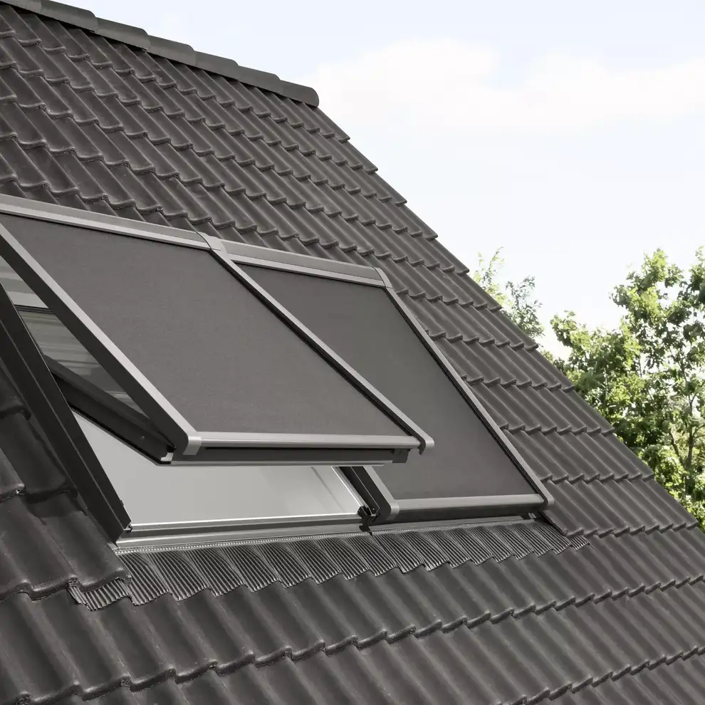 Modern roof with VELUX window partially open, dark ceramic tiles.